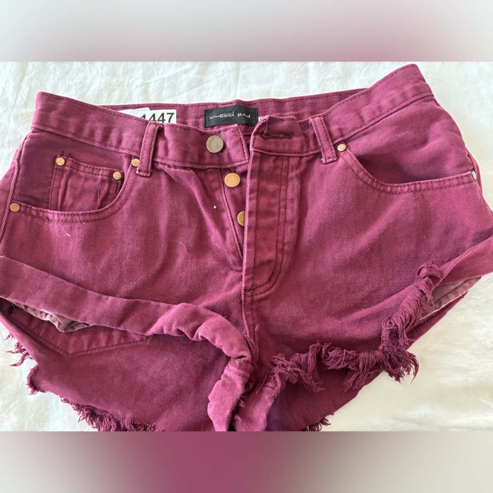 Mustard seed. Size medium, dark maroon Daisy Duke shorts good condition.